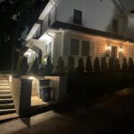 Side of house at night time with lighting